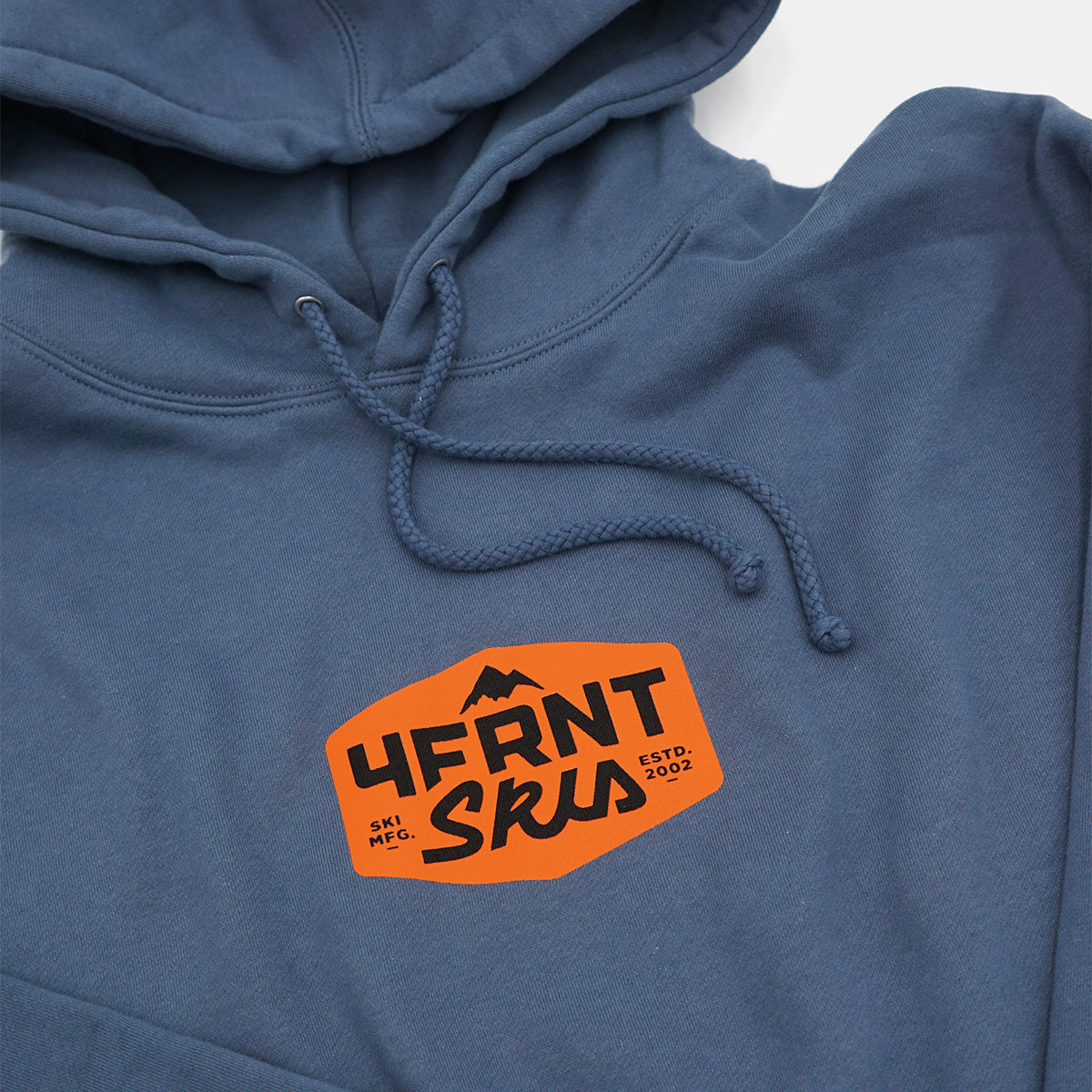 the 4frnt skis blue MFG with an orange badge hoodie detail view