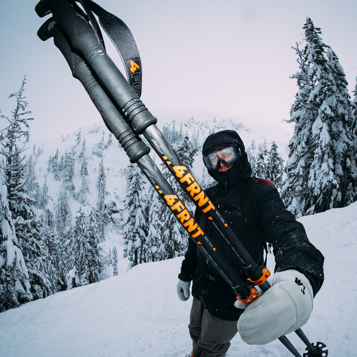 fisheye image of a skier holding 4frnt ski poles