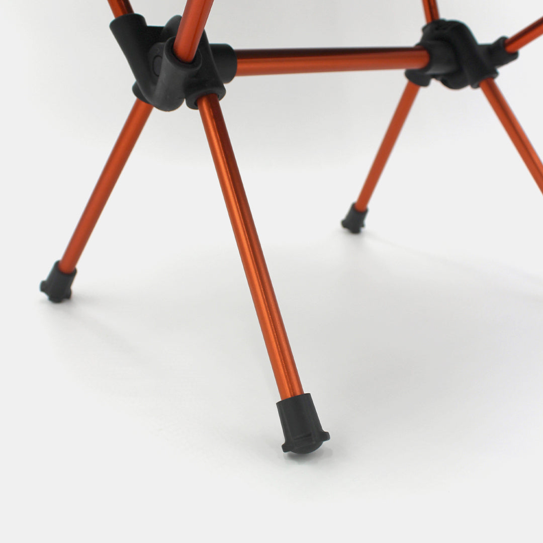 4frnt orange and black Collapsible Lot Chair close up of legs