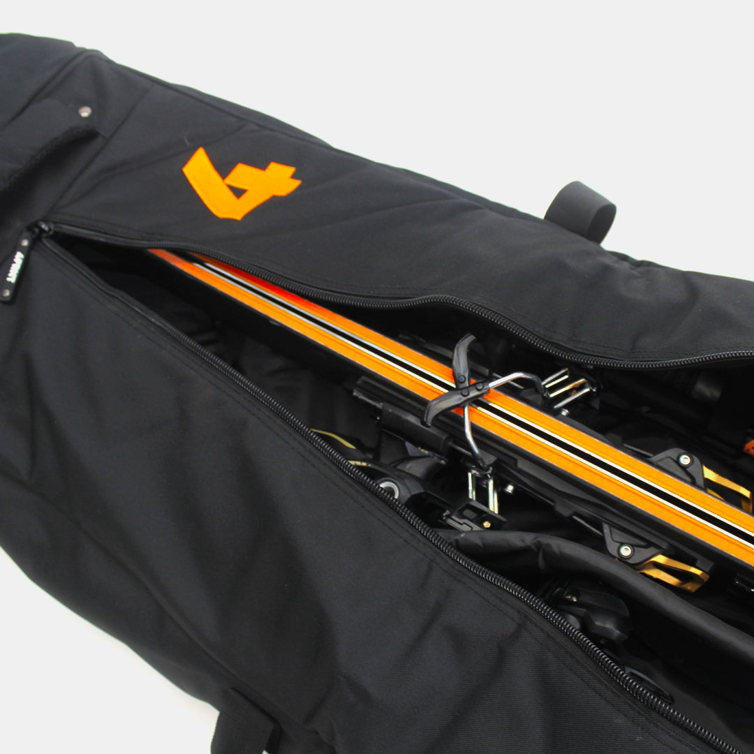 4frnt skis black and orange double ski roller bag unzipped with gear inside